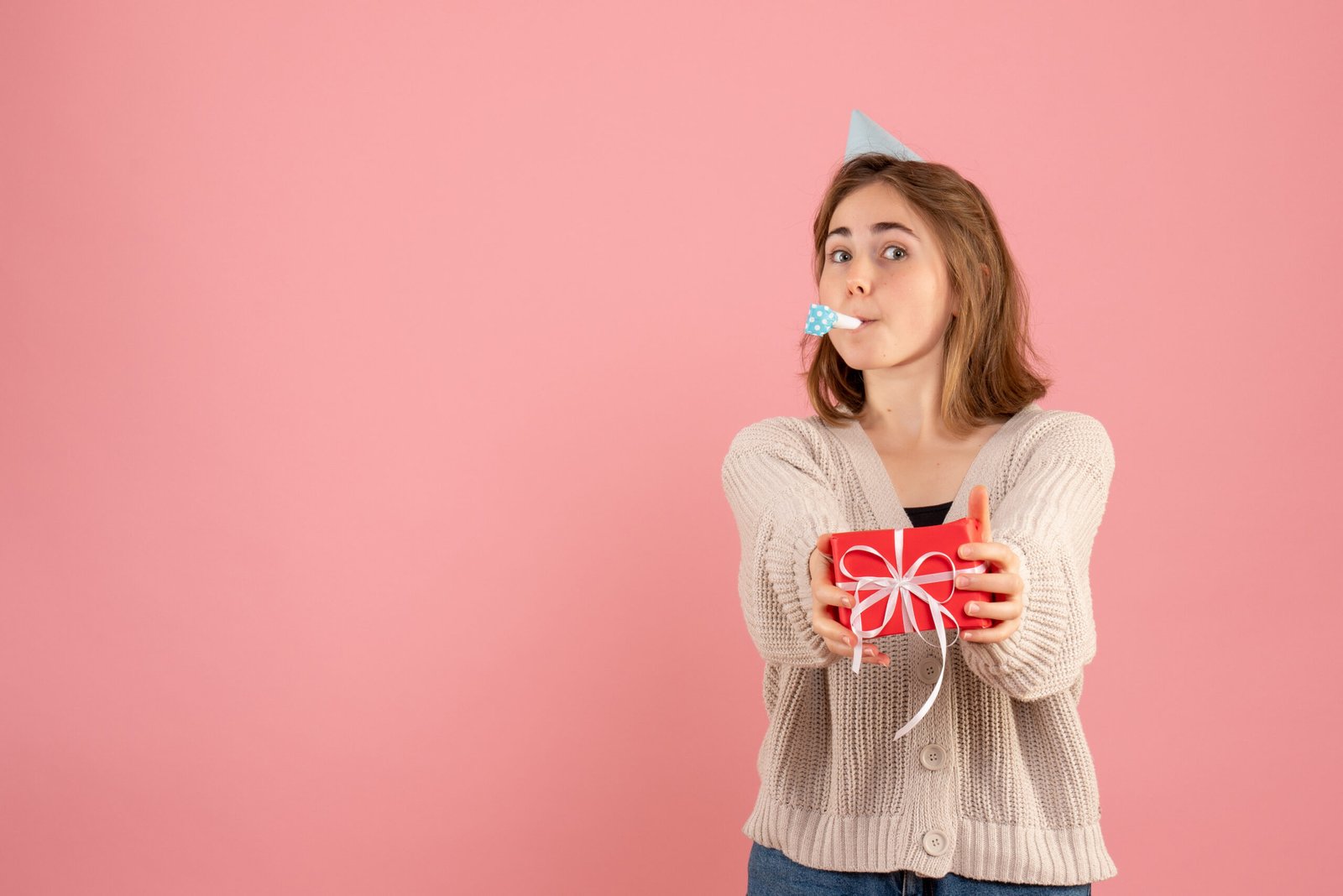 young female holding little xmas presents pink
